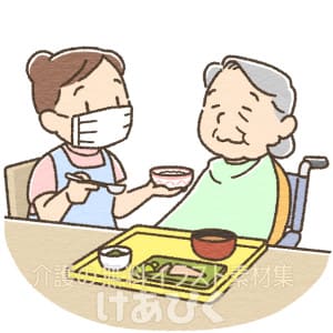 マスクをして食事介助する介護士のイラスト