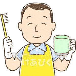 歯ブラシを持つエプロンの男性